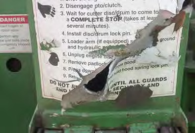 Damaged metal guard on a wood chipper